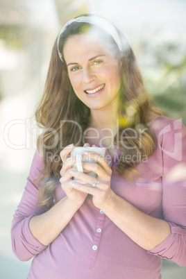 Portrait of happy woman with coffee