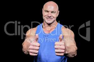 Smiling healthy man showing thumbs up
