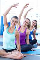 Portrait of happy women in easy pose with hands raised