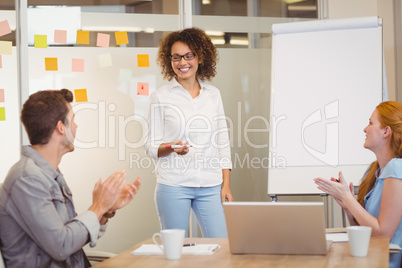 Colleagues appreciating businesswoman in meeting