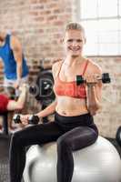 muscular smiling woman do some weightlifting