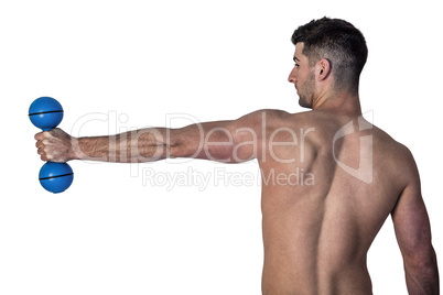 Man stretching arm while holding dumbbell