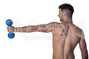 Man stretching arm while holding dumbbell