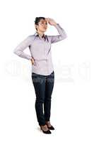 Businesswoman looking upwards with hands on hips