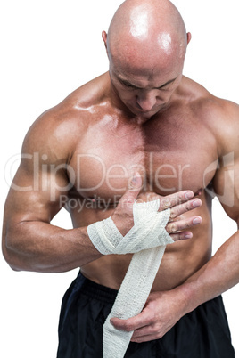 Fighter tying bandage on hand