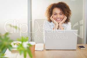 Portrait of businesswoman with hand on chin