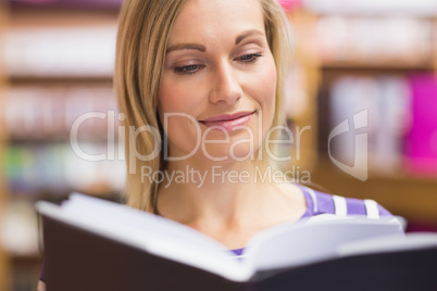 Close-up of young woman reading book