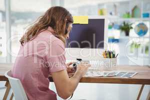 Hipster using camera while sitting at desk