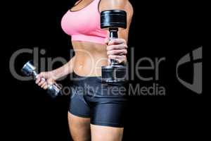 Close-up of dumbbells by slim woman