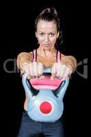 Portrait of fit woman lifting kettlebell