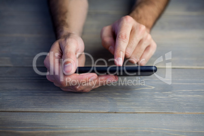 Person using mobile phone at desk