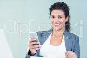Smiling businesswoman using smart phone