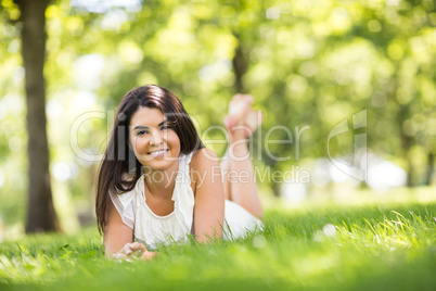 Portrait of beautiful woman lying on grassland