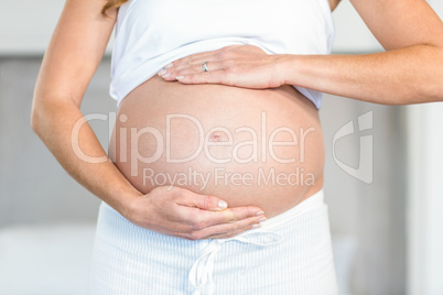 Midsection of woman holding abdomen
