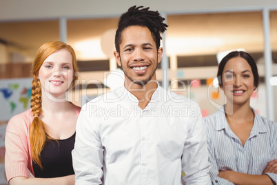 Portrait of confident smiling businessman with female colleagues