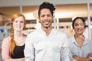 Portrait of confident smiling businessman with female colleagues