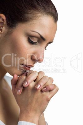 Close-up of woman praying with joining hands and eyes closed