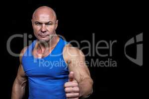 Portrait of confident muscular man showing thumbs up