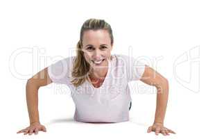 Portrait of happy fit woman doing push ups