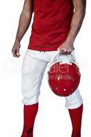 Rugby player holding helmet