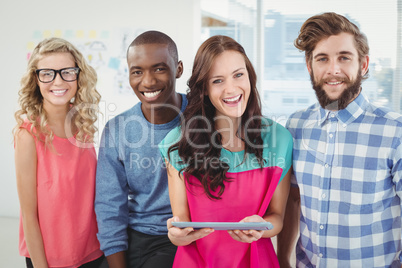 Portrait of happy business professionals using tablet