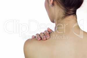 Topless woman massaging back against white background