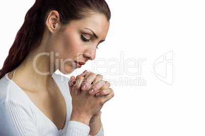 Woman praying with joining hands and eyes closed
