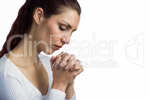 Woman praying with joining hands and eyes closed
