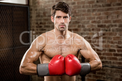 Portrait of a serious man wearing boxing gloves