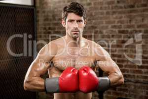 Portrait of a serious man wearing boxing gloves