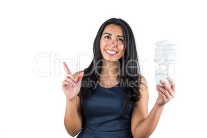 Woman pointing her finger and holding a light bulb