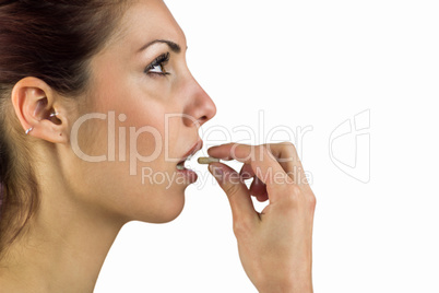 Close-up of woman taking pill