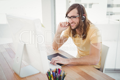 Hipster working at computer desk