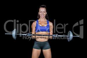 Portrait of smiling woman lifting crossfit