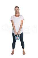 Happy sporty woman exercising with kettlebell