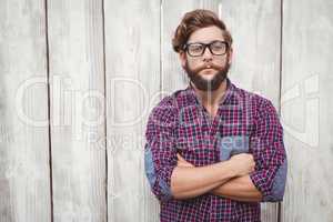 Confident hipster wearing eye glasses with arms crossed