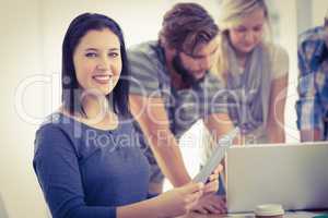 Portrait of smiling businesswoman with digital tablet