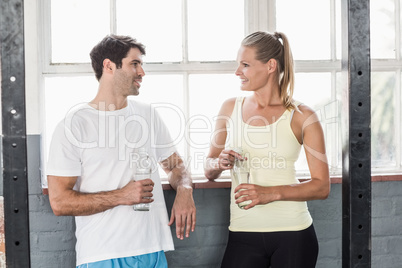 Fit couple holding water bottles