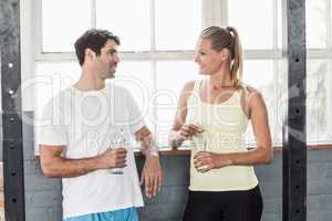 Fit couple holding water bottles