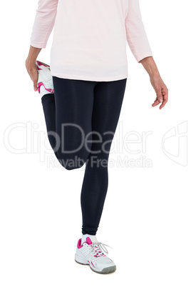 Low section of mature woman exercising