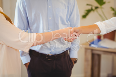 Clients shaking hands with businesswoman