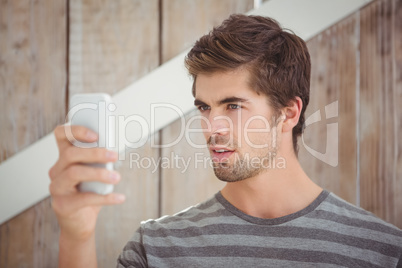 Man looking at mobile phonewhile standing