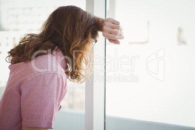 Side view of man looking through window