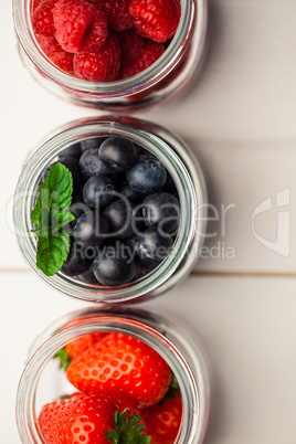 Glass jars of fresh berries