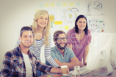 Portrait of happy business professionals working at computer des