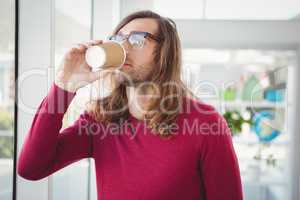 Hipster drinking coffee in office