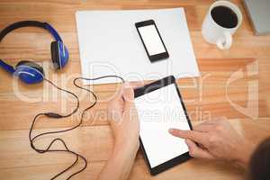 Man using digital tablet with headphones