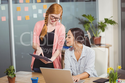 Businesswomen using technologies in office