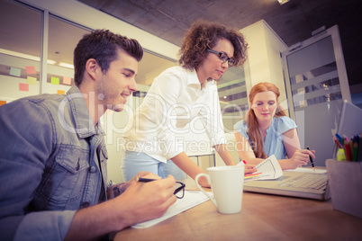 Business people looking at laptop