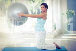 Portrait of pregnant woman holding exercise ball